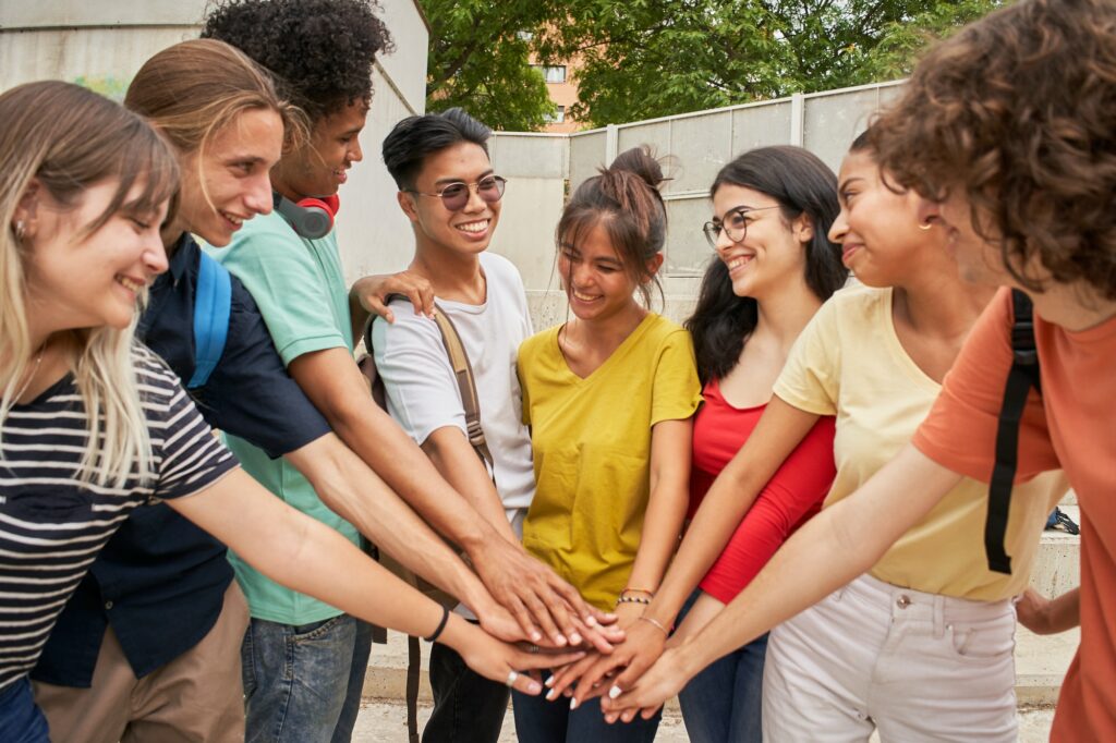 Group of students having a good time together, cheerfully celebrating, happy and motivated.